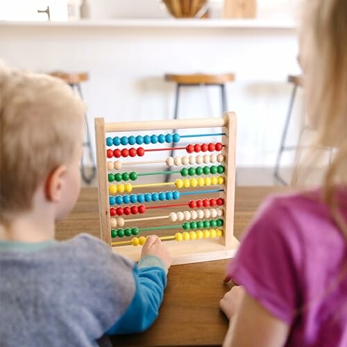 Children playing with a colorful abacus on a table