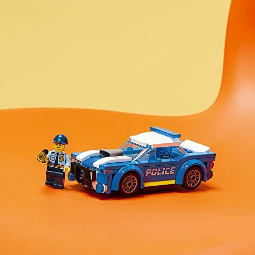 LEGO police car and figure on orange background.